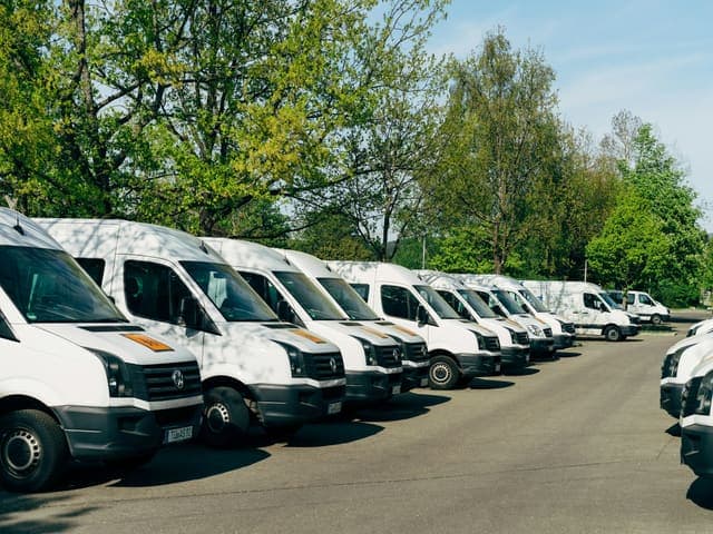 Row of white delivery vans