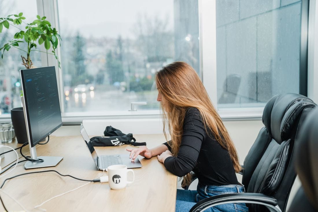 A Margins engineer working at her desk by the window
